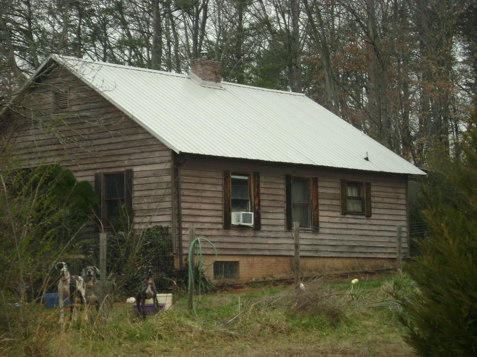 White metal roof on an old wood sided farmhouse, from a Metal Roof Installation job in Gwynedd Valley